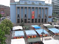 Square below filled with vendors, mostly veggies and flowers